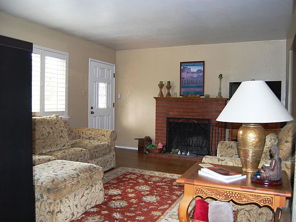 Living room looking toward front door and fireplace.