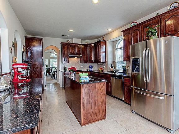 GOURMET ISLAND KITCHEN FEATURING GRANITE TOPS, 42 INCH CABINETS & STAINLESS STEEL APPLIANCES ~