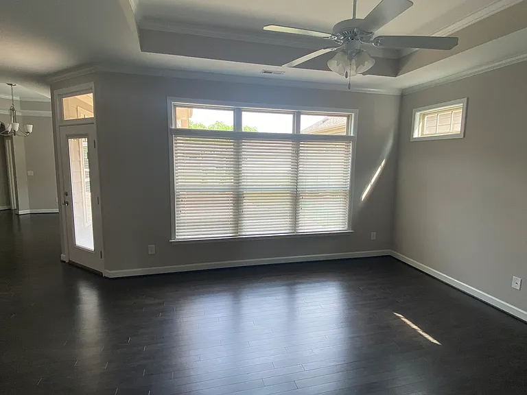 living space with vaulted ceilings towards large windows and plenty of natural lighting