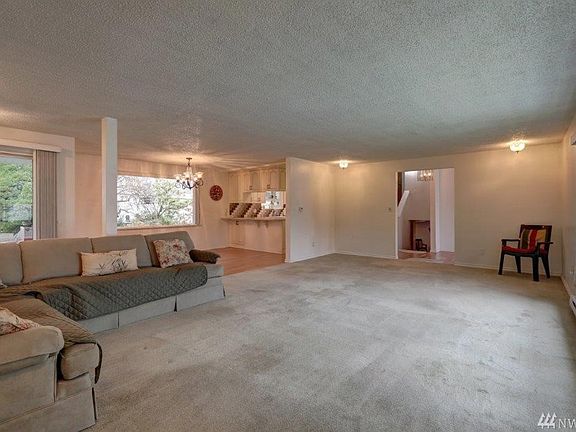Living room looking towards kitchen/dining area and stairs to recreation room.