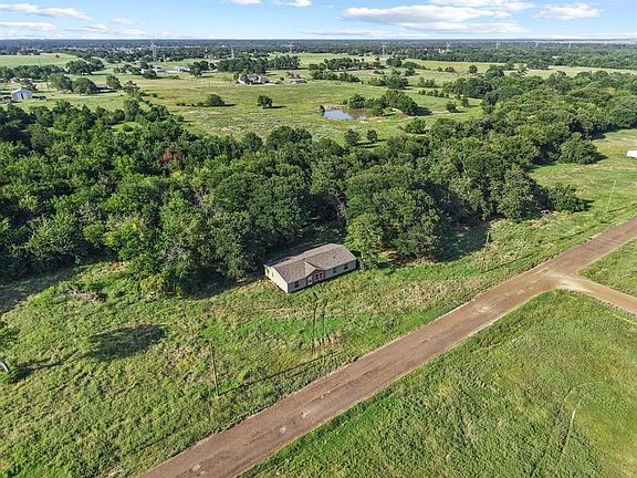 Aerial view of property''s location featuring a nearby body of water and rural landscape