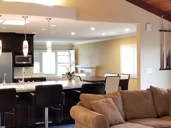 open floor plan with kitchen overlooking huge (500sqf) family room; formal living room has a custom built fireplace