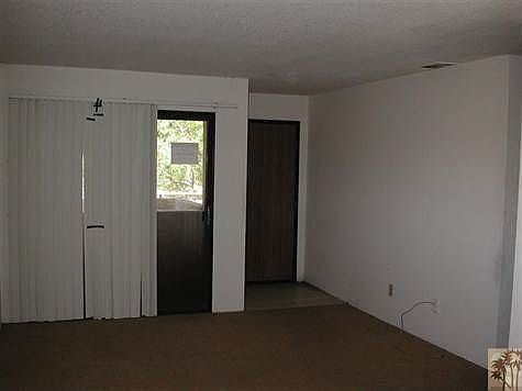 Living room with sliders to covered balcony.