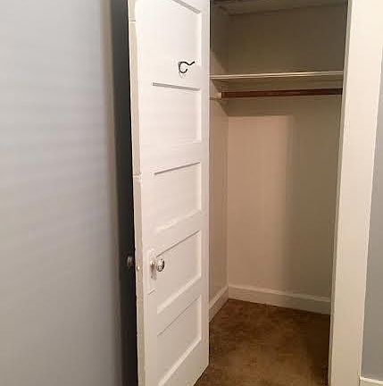 Bedroom closet with shelf above for additional storage (photo is old and carpet has been since updated to the grey carpet seen in the other photos.