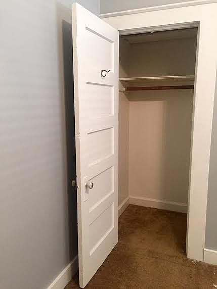 Bedroom closet with shelf above for additional storage (photo is old and carpet has been since updated to the grey carpet seen in the other photos.