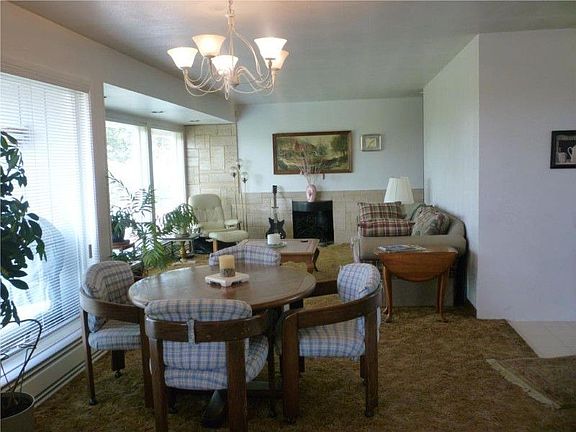 The open and airy "great room" concept living area-a wok style fireplace with marble tile accents is