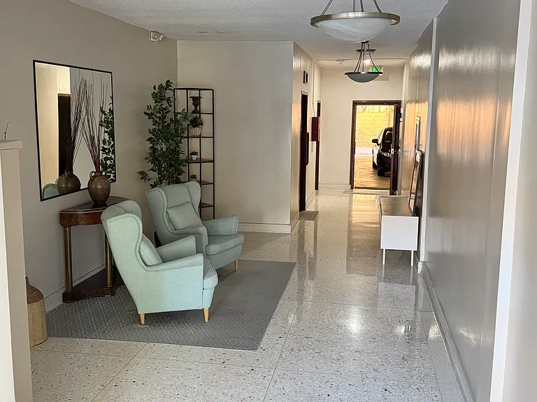 Lobby leads to garage entrance and laundry facilities
