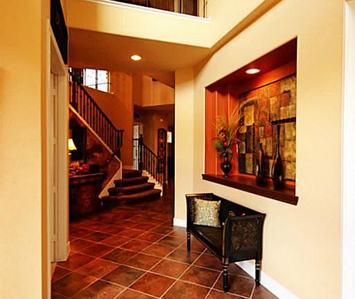 Come inside! The light and open foyer has a gracious art niche, tile floors, and tall ceilings.