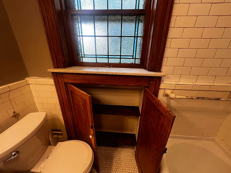Storage under bathroom window.