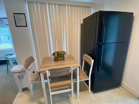 Enjoy a cozy dining space with equipped kitchen and refrigerator.