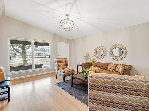 Large windows open to the covered front porch to let in natural light.