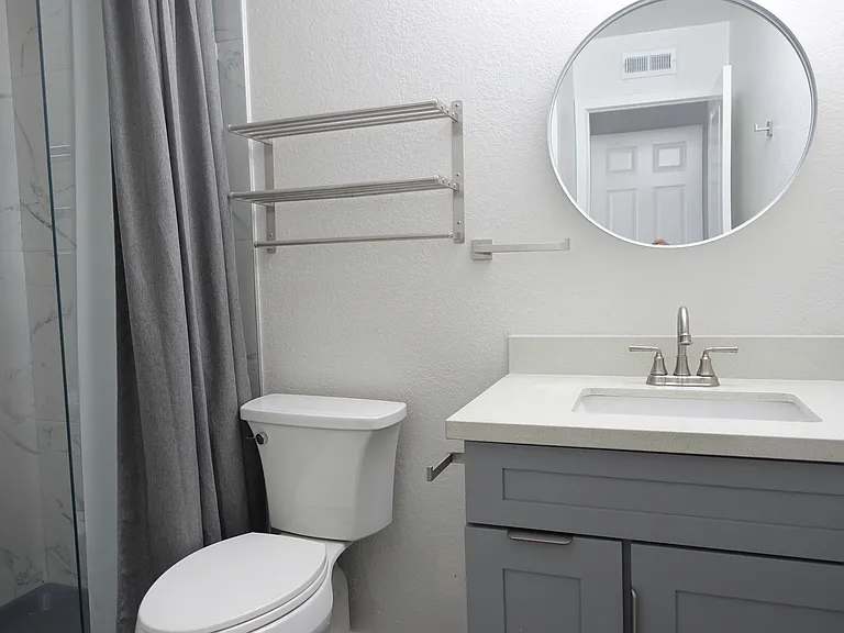 Bathroom #1: Full bath. Walk-in shower with marble tiles and recessed shower cubby. New cabinet and fixtures