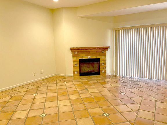 Fireplace in living room. Sliding door off to backyard.