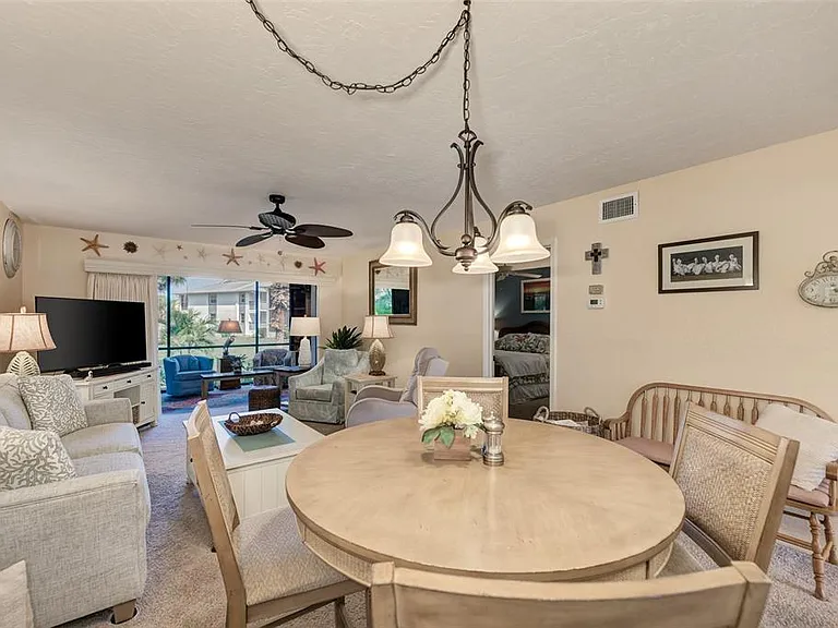 Our open-concept living and dining area is designed with a "classy coastal" vibe that brings the beauty of the Gulf inside. Whether you're sharing a meal at the table or lounging in the living room, the seamless flow every moment feel like a vacation.