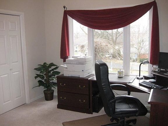 Bedroom 1 with a double door closet, large windows & view of Weatherby Lake!