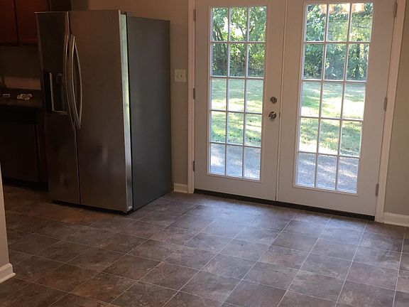 French doors off dining area/kitchen looking onto back patio
