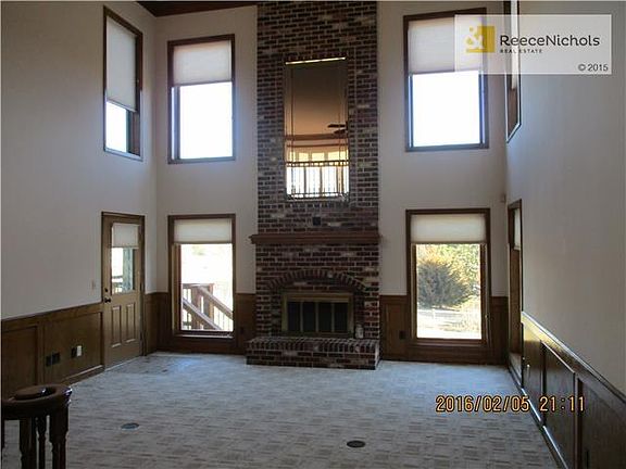 Grand two story great room overlooking shared pond.  Walks out to deck and then down to huge patio.