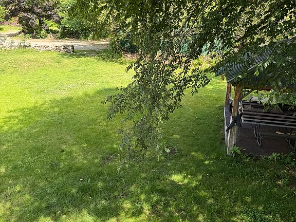 Overlooking the railing from the porch down to the picnic area