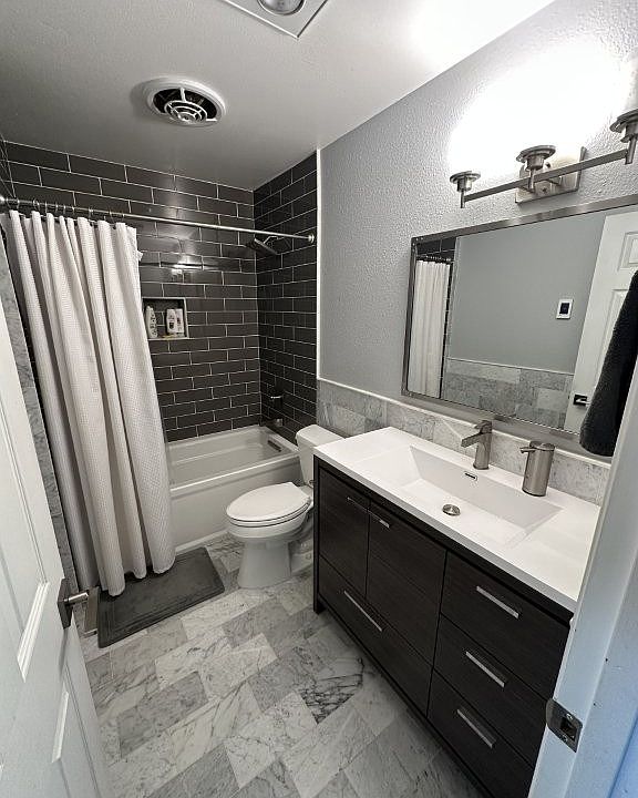 renovated hall / guest bath with heated tile floors
