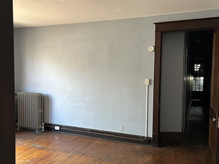 Living room with hallway to front door on right