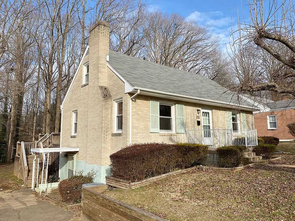 Brick exterior with front porch, driveway and street parking