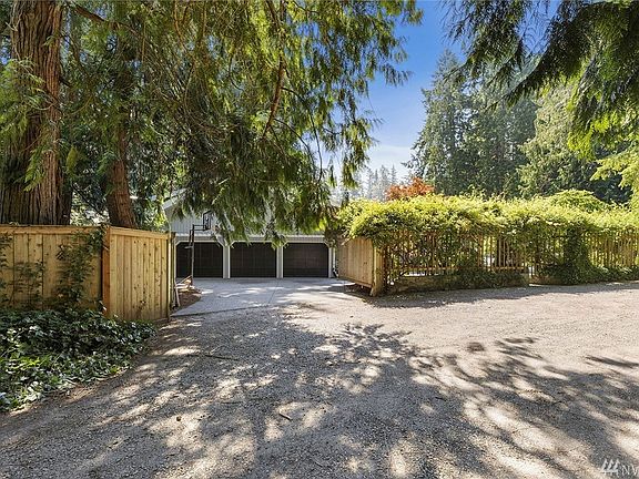 Entering from the private, shared road, this fenced yard opens onto the 3 car garage. The parking surrounding the home is massive (up to 12 vehicles). Inside of the garage is plenty of space, including power to add charging station for an Electric Vehicle.