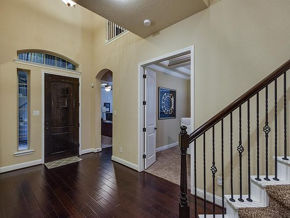 Impressive entry with gleaming wood floors that lead to the formal dining and study.