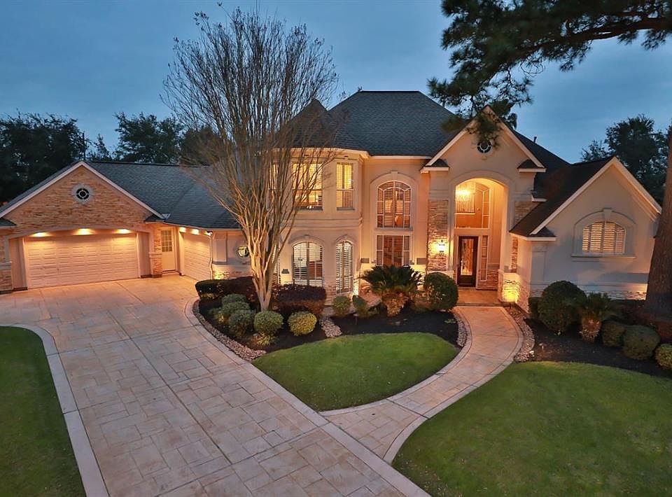 CUSTOM HOME BUILT BY FLAIR - HAS THAT WOW FACTOR! This picture perfect home is located in a unique exclusive gated community inside Champion Forest. Pleasantly designed with TWO bedrooms down, 4 car garage with granite chipped epoxy flooring, formal 