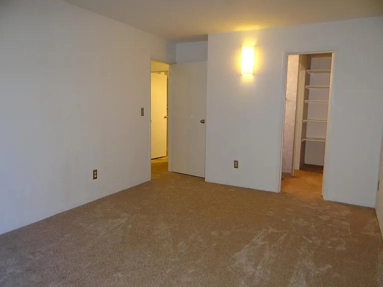Primary Bedroom showing walk in closet and bath