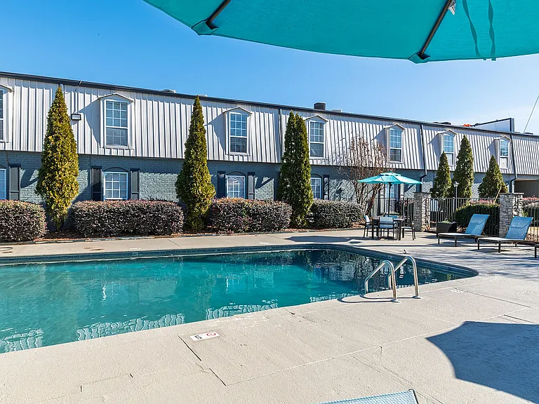 Relax and unwind at this chic apartment's outdoor pool, perfect for sunny days.