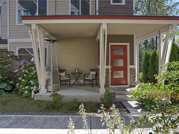 An incredible build with rock accent, check out this covered front portico with modern door that lets in the sunlight!