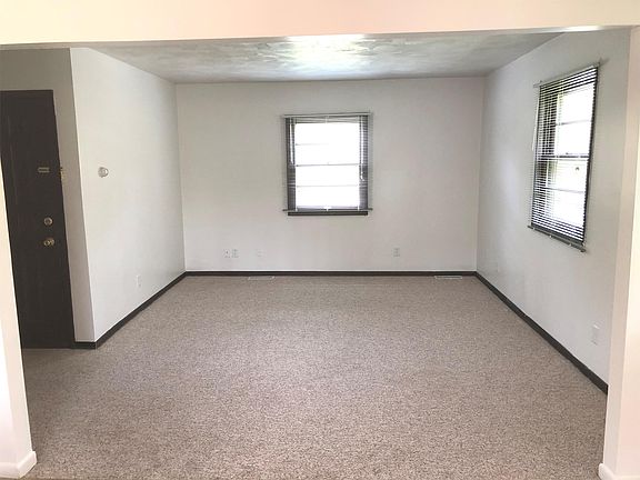 Entryway leads to large and bright living room that opens up to sizable country kitchen.