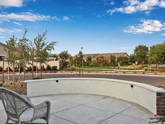 Expanded front patio for your morning coffee with a rare view of the walking path that leads to all the HOA amenities!