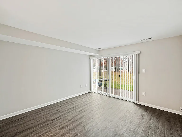 Experience serene living in this airy room with direct patio access.