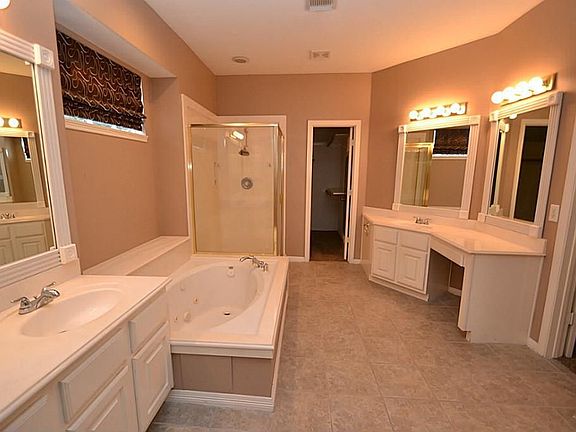 Master bath offering tile flooring, double sinks, vanity are
