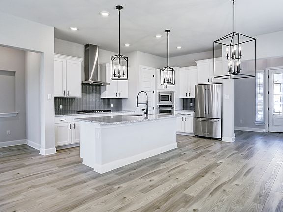 Fully-equipped kitchen with top-tier appliances and an oversized island.