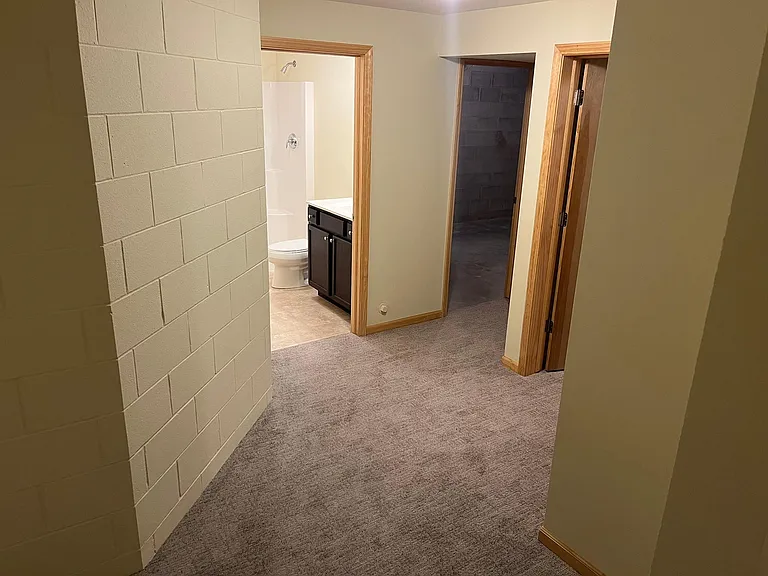 Lower level full bath, bedroom, and storage.