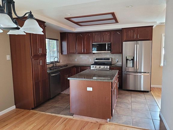 Updated kitchen and appliances with island and granite counter tops.