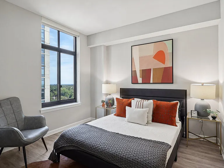 a bedroom with a bed and a large window