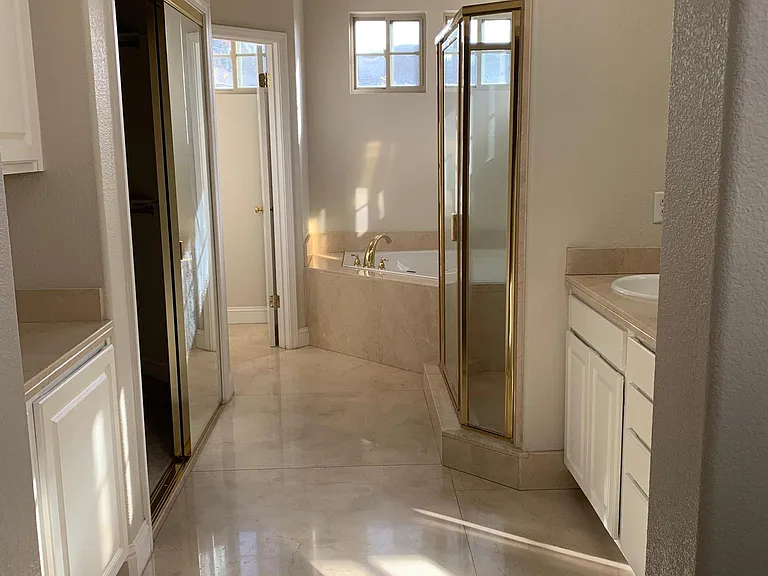 Master bath with a walk-in closet