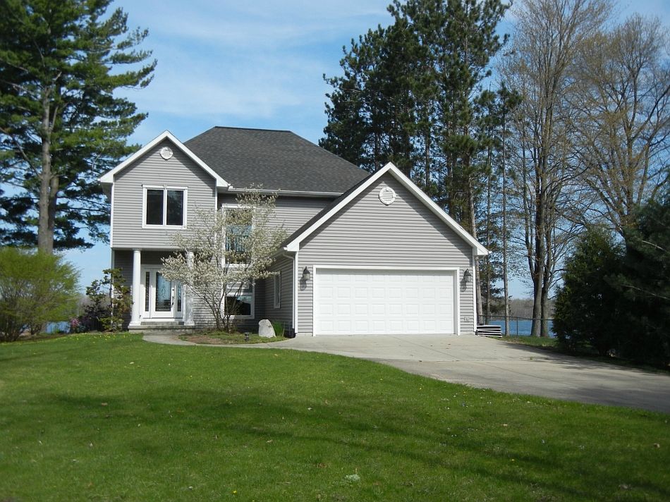 Pristine Waterfront Escape built by Rob Case!  This 2002-built home provides numerous large windows and outdoor spaces that offer exceptional views of Wixom Lake. Many of the great features to this home include; a large finished walkout basement with kitchen, large porch off the master, open kitchen with granite counters and maple cabinets, steel seawall, marble tile floors in the bathrooms, sprinkler, natural gas, and city water at the road!  The property is at the SE end of Wixom Lake and only about 22 minutes from the Midland Mall.  Come see it today!