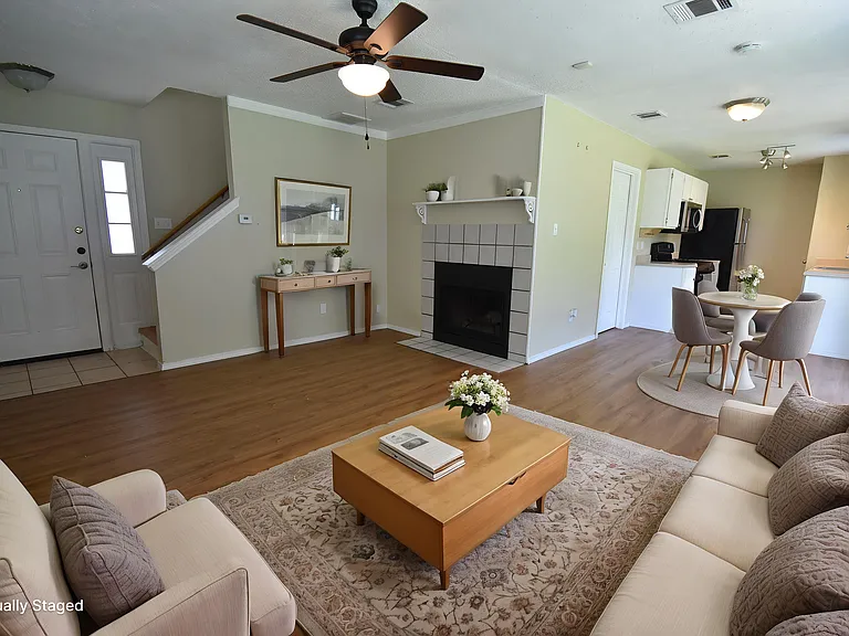 Virtually staged living room with a dinning room and a kitchen in the background