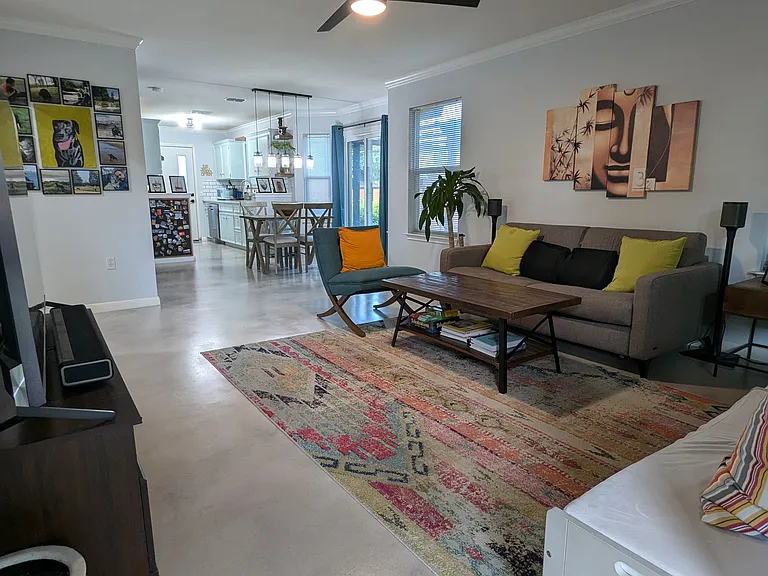 Welcome to the open-concept living-dining with beautiful modern stained concrete flooring