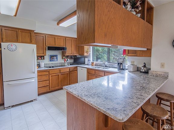 The kitchen looks over the back yard and is sporting new quartz countertops!