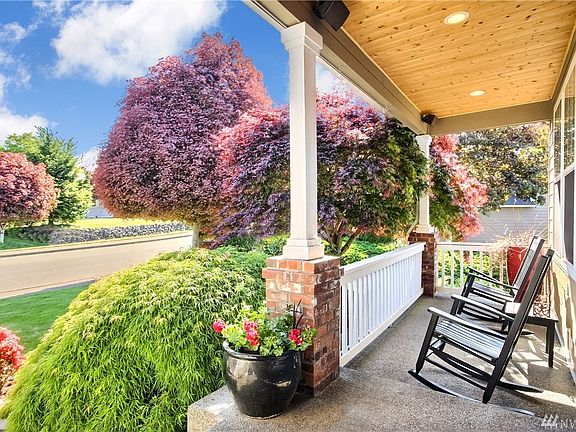 Spacious Front Porch w/ tongue & groove pine ceiling, perfect for enjoying the beautiful landscaping