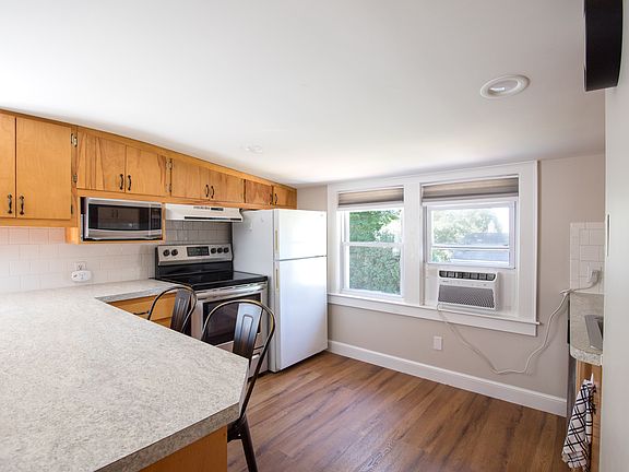 Full kitchen with refrigerator, stove, microwave and dishwasher.