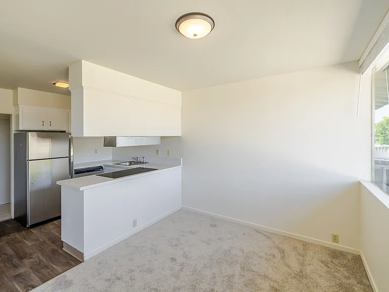 Bright dining nook with large window and easy kitchen access.