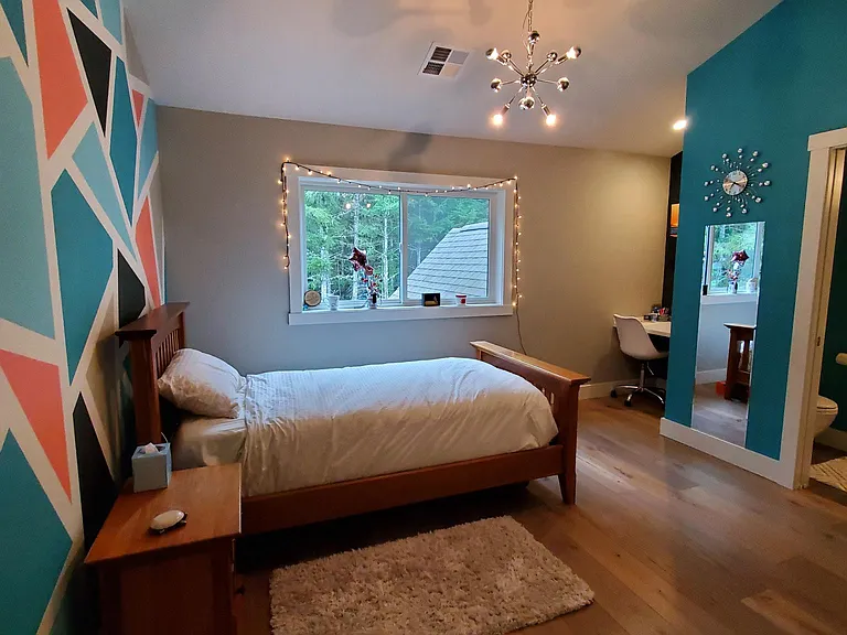 Ensuite bedroom with a desk area, large closet, and full private bathroom