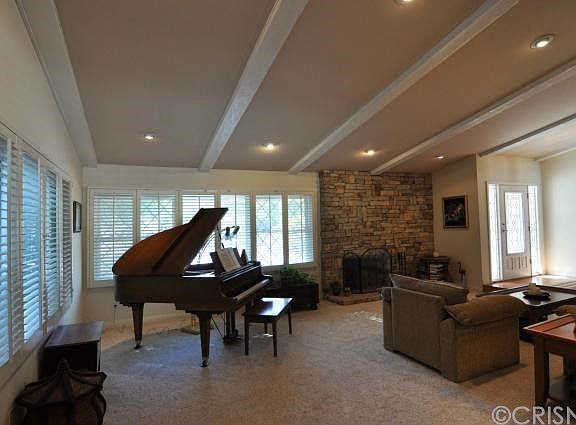 ANOTHER VIEW OF THE LIVING ROOM, PLANTATION SHUTTLERS AND FIREPLACE