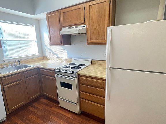 Fully equipped kitchen with Euro-style electric range, dishwasher and fridge.